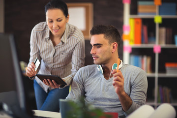 Casual business partners working together at the office