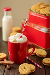 Marshmallows in a Cup with cookies with hearts out of the jam.