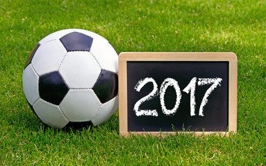 Soccer 2017 - chalkboard with leather ball on green grass - Powered by Adobe