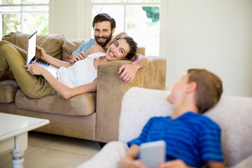 Parents talking to a son while using laptop