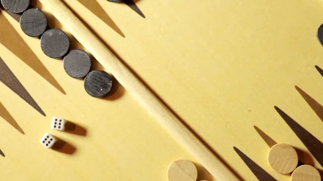 Panning shot of a backgammon board with dice, double six.