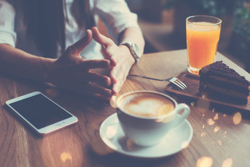 Woman with mobile phone on the table, reading new incoming messages in mailbox, breakfast of handsome business lady
