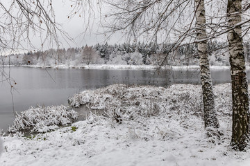 White winter landscape lake in the forest