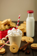 Marshmallows in a Cup with cookies with hearts out of the jam.