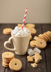 Marshmallows in a Cup with cookies with hearts out of the jam.