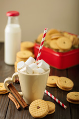 Marshmallows in a Cup with cookies with hearts out of the jam.
