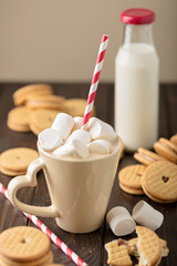 Marshmallows in a Cup with cookies with hearts out of the jam.