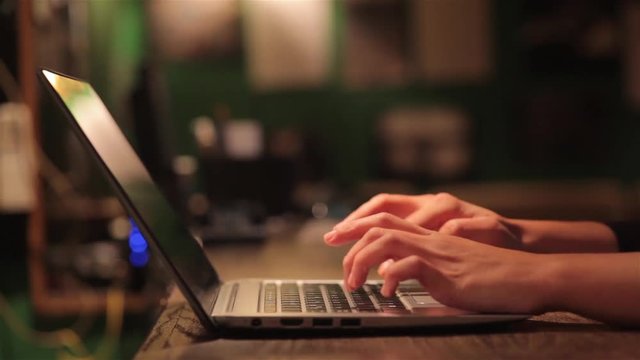 Still shot of a woman's hands working on a laptop.
