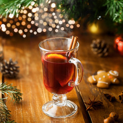 Mulled wine with citrus fruits and cinnamon on a table. Traditional winter hot drink for Christmas Eve party..