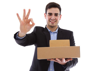 young man with packages of cardboard in the hands and doing ok prompt