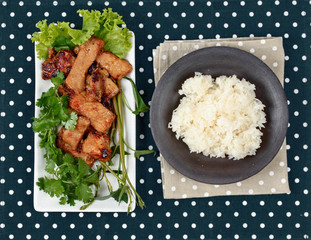 Grilled pork with mixed herb served sticky rice .