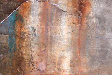 old plaster wall with rusty stains from water