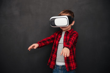 Child wearing virtual reality device over blackboard