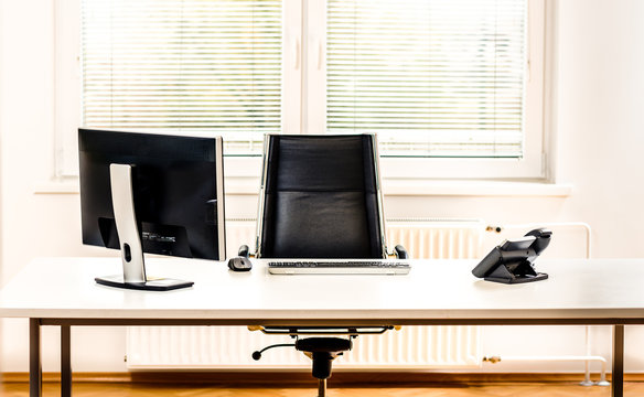 Modern Empty Office Space Desk With Computer, Phone And Chair.