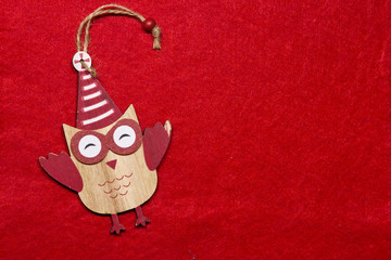 Christmas toy. Wooden owl on a tree.