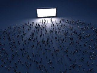 group of people looking at the screen at night