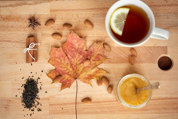 cup of lemon tea and honey on wooden board