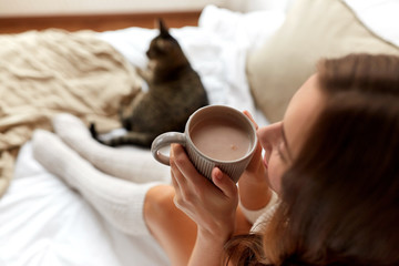 close up of happy woman with cocoa cup at home