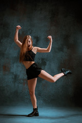 Fototapeta na wymiar Attractive girl dancing twerk in the studio