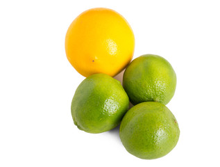 Closeup of fresh limes and orange.