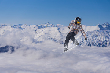 Snowboard rider jumping on mountains. Extreme snowboard freeride sport.