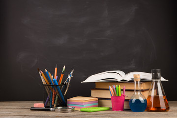 Education concept - books on the desk in the auditorium