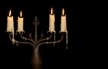 burning old candle vintage bronze candlestick. Isolated Black Background. - obrazy, fototapety, plakaty