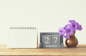 vintage wood calendar for january day 27 on wood table with empt