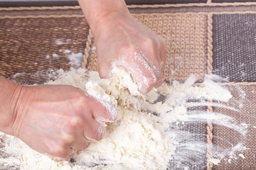 Male hands making dough.