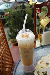 Take-home ice coffee cup on wooden table
