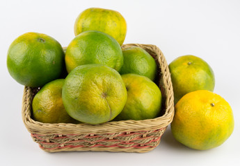 oranges in a basket isolated on white background