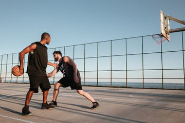Two sportsmen playing basketball