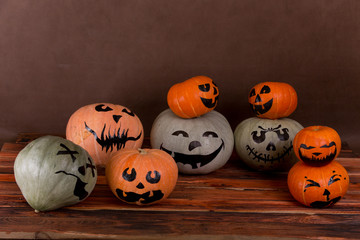Funny Jack-o-lantern pumpkins on a wooden table