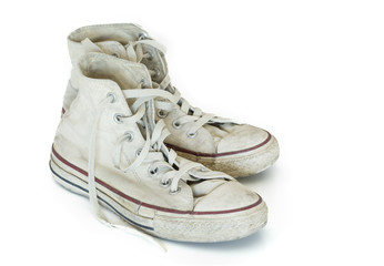 Old white sneakers on white background