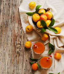Fresh apricot juice in glass on wooden table, selective focus