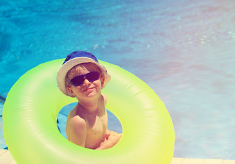 happy little boy having fun at the pool
