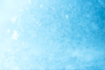 Fototapeta na wymiar Snow bright abstract winter background close-up bokeh