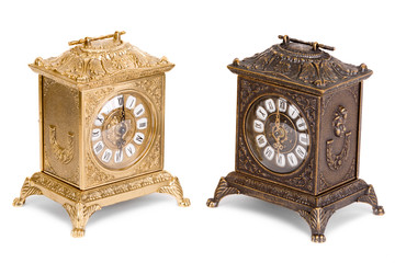Vintage golden and bronze clocks on a white background