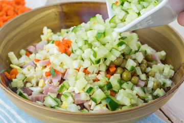 Ingredients for traditional russian olivier salad with ham veget