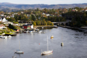 European village in miniature, fishing boats, tilt shift effect, 