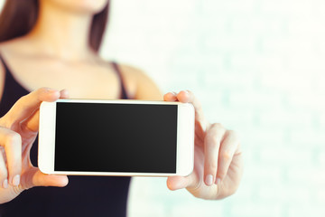 Woman with modern mobile phone in hands