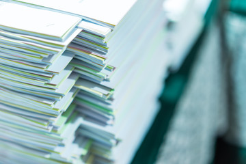 Colorful piles of paper stacked on a table placed.