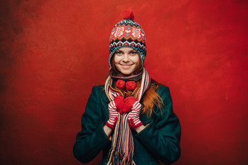 Pretty smiling woman in a funny hat on bright background
