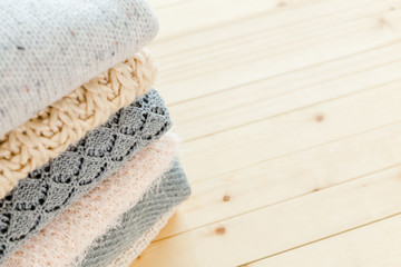 Obraz na płótnie Canvas Stack of white cozy knitted sweaters