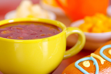 Yellow bowl with traditional tasty latin american colada morada berry juice, symbolizing blood from those deceased, day of the dead concept