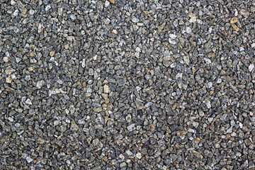 Background of randomly packed small granite stone pebbles