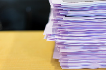 Place the stack of papers on the table