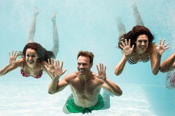 Happy friends swimming