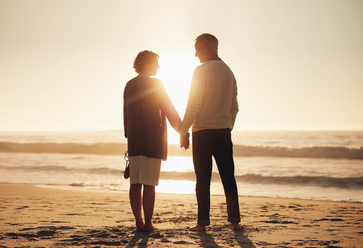 Senior couple standing on a beach together