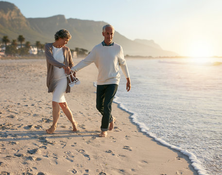 Senior couple walking leisurely on the beach